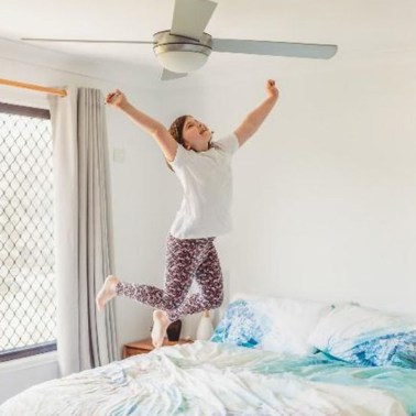 Child jumping on a bed