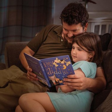 Dad reading his daughter a story