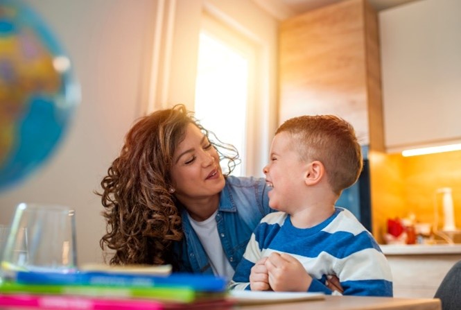 Mom and son looking and smiling at each other