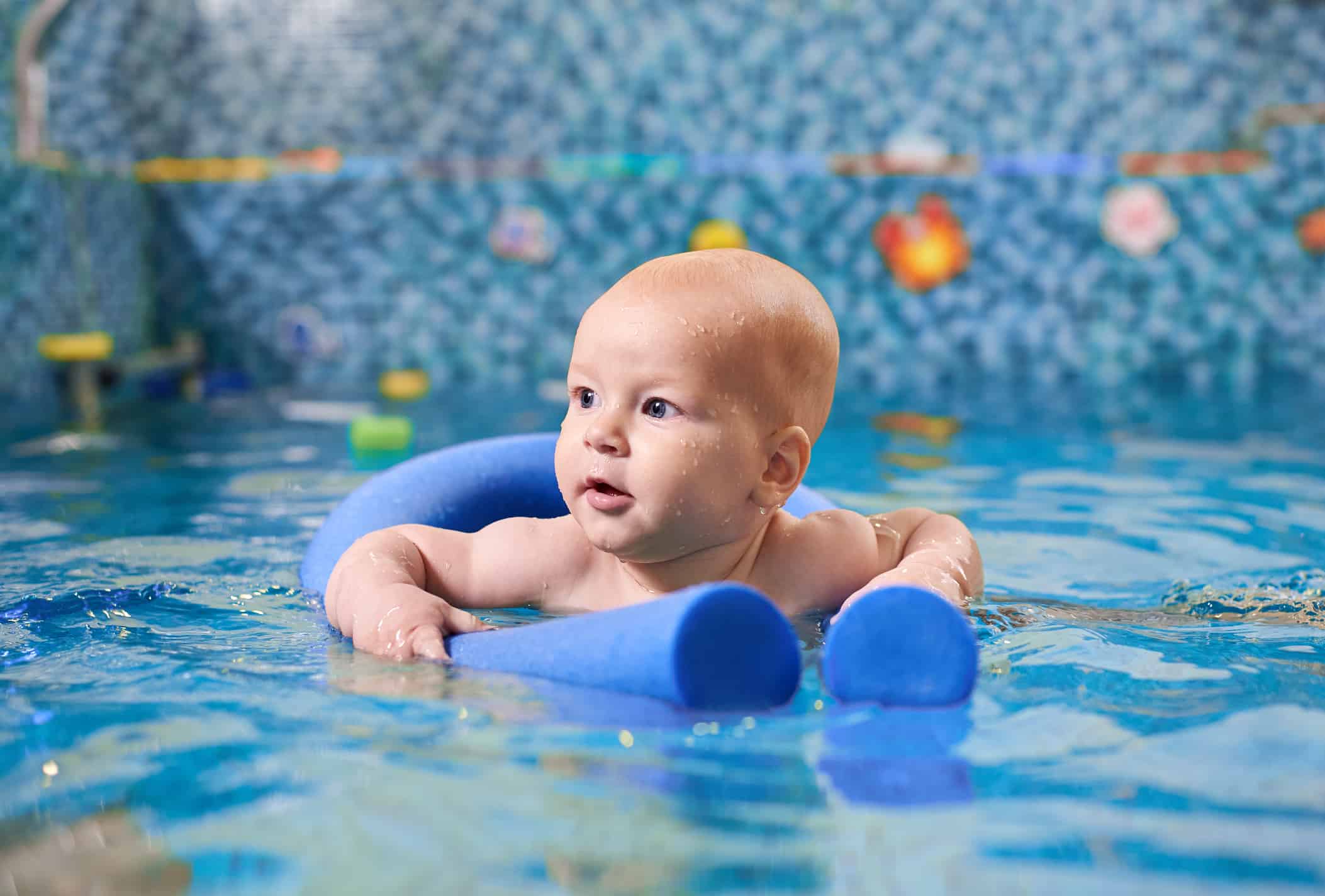 Baby with floatation device in a pool